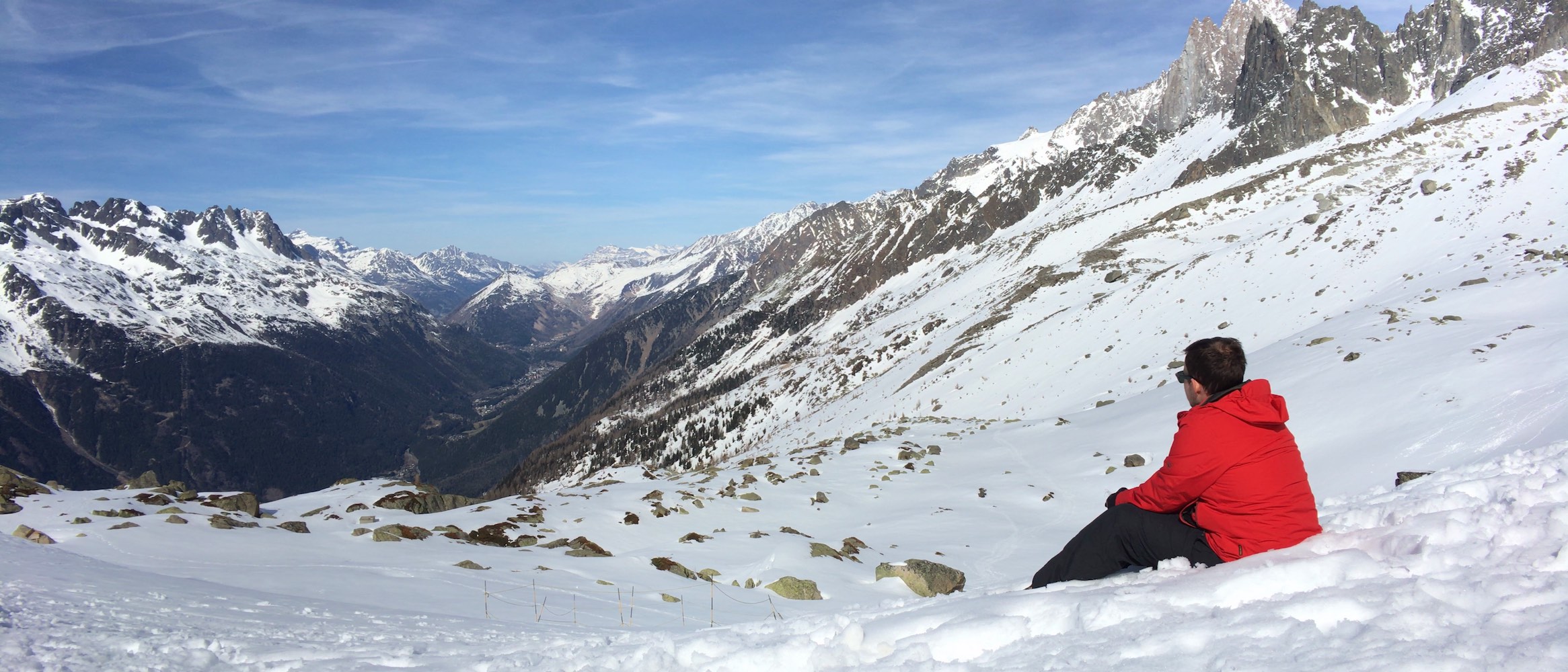 Ben Hoad sitting in the snow in the mountains above Chamonix